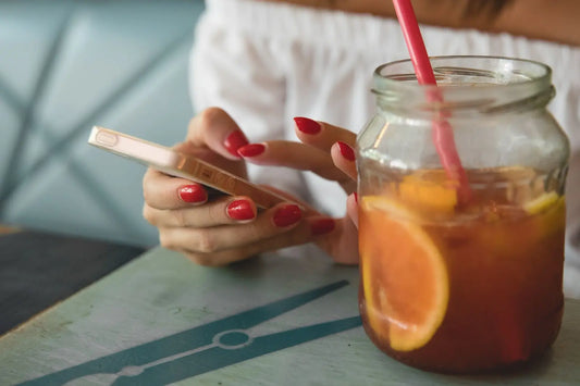 Lady with painted nails on her phone
