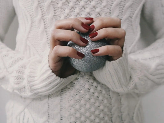 Lady with painted nails holding a rock