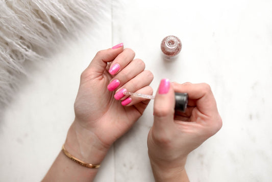 A woman painting glitter nails