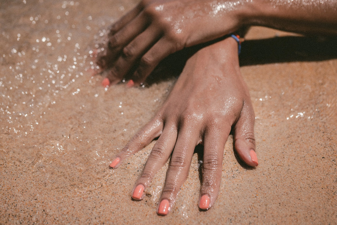 A hand in the sand