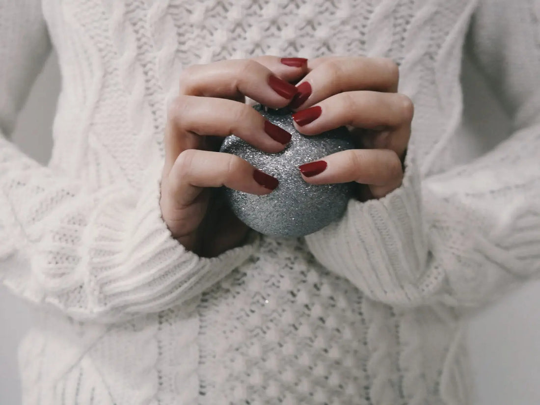 Lady with painted nails holding a rock