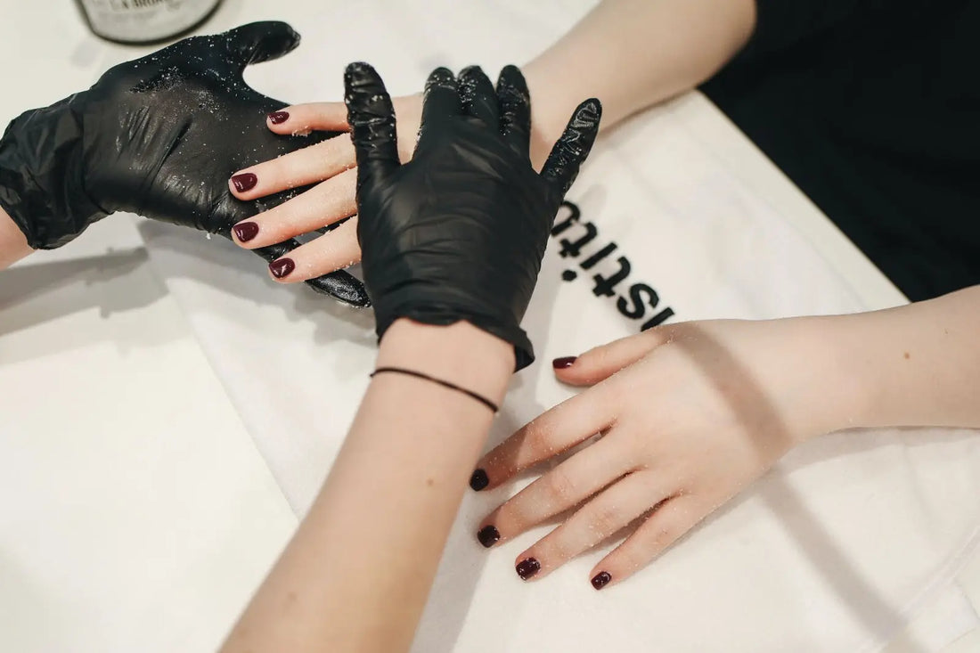 Someone giving a woman a manicure