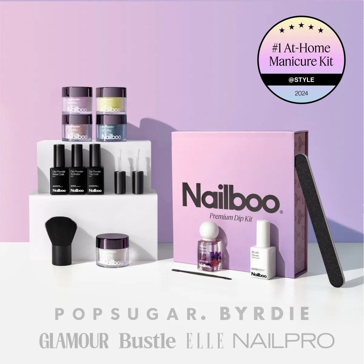 Nailboo dip powder kit with accessories and free cuticle oil on a pink background.