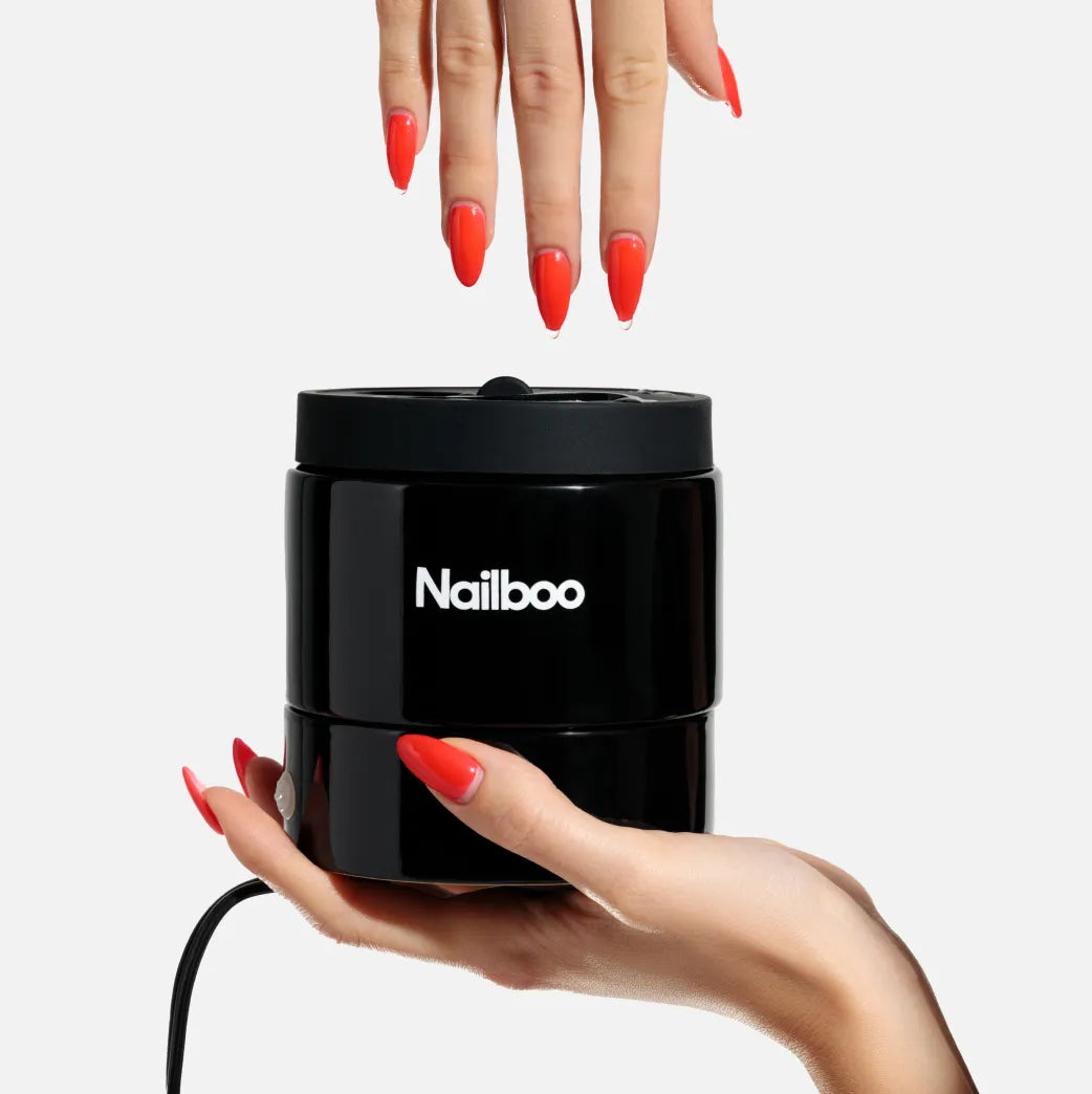 Nailboo manicure set with nail polishes, tools, and promotional offers against a pink background.