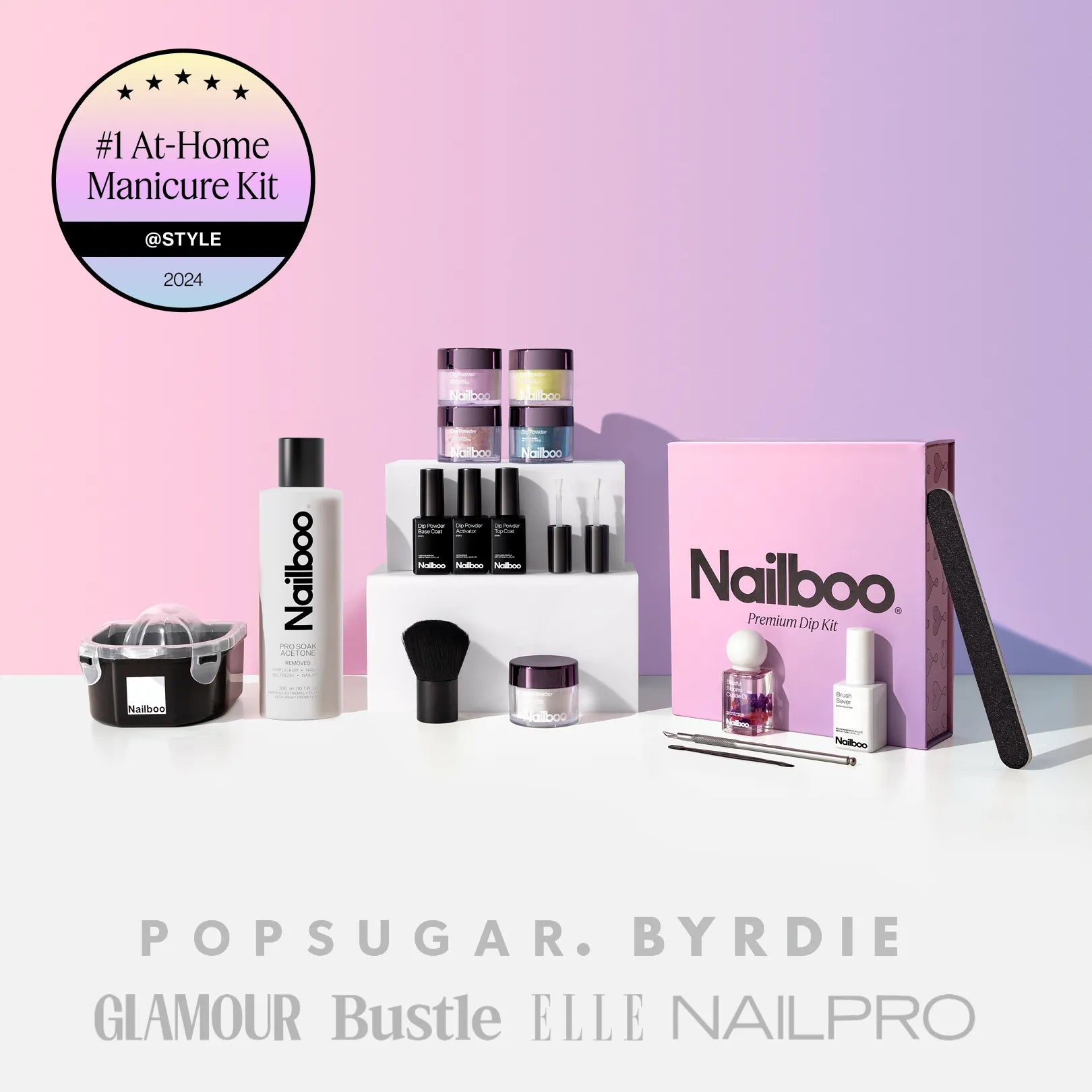 Nailboo dip powder kit with accessories and free cuticle oil on a pink background.